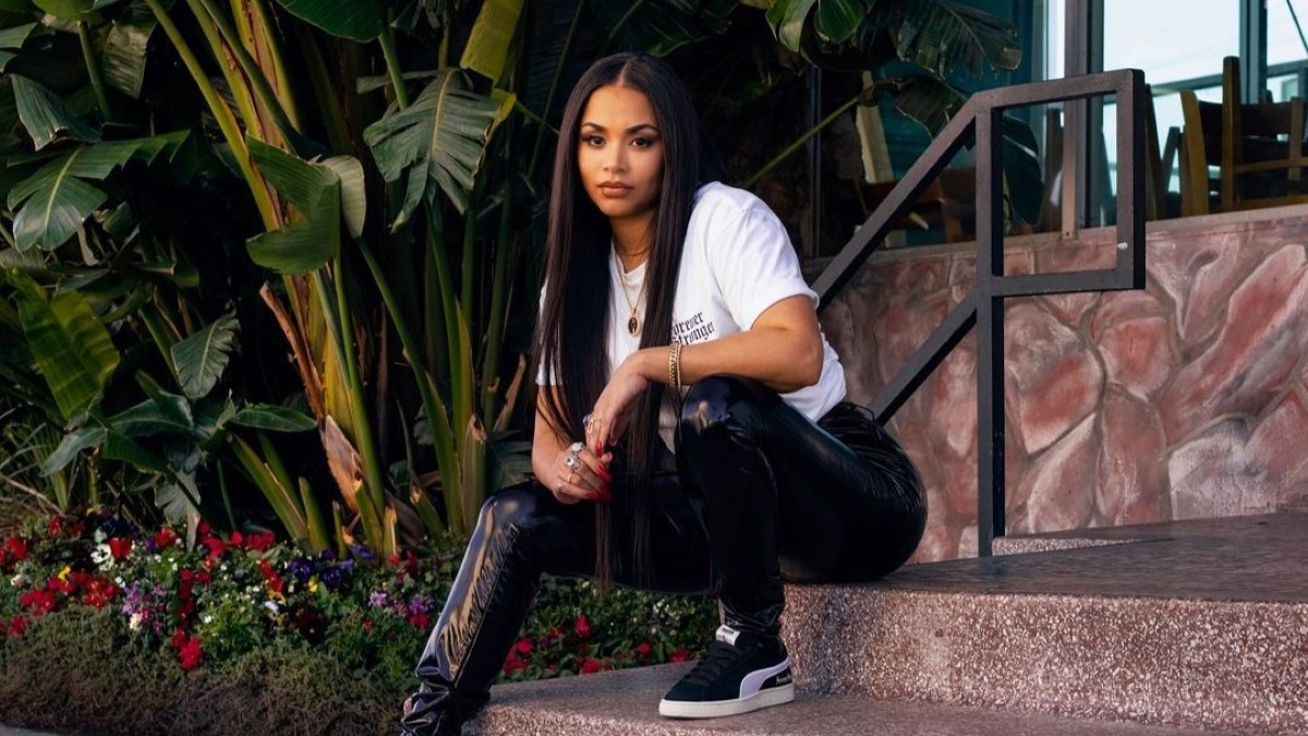 Lauren London posing for a camera in white and black