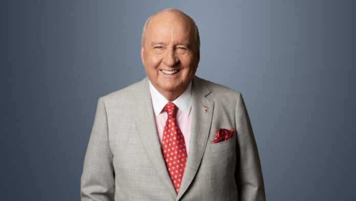 Alan Jones wearing a grey blazer