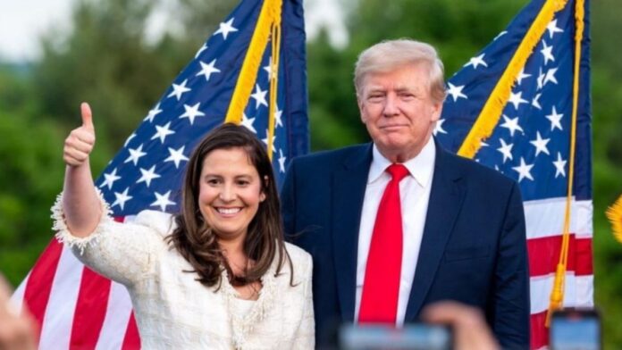 Elise Stefanik standing with Donald Trump