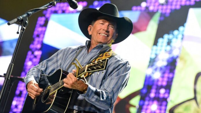 George Strait holding a guitar